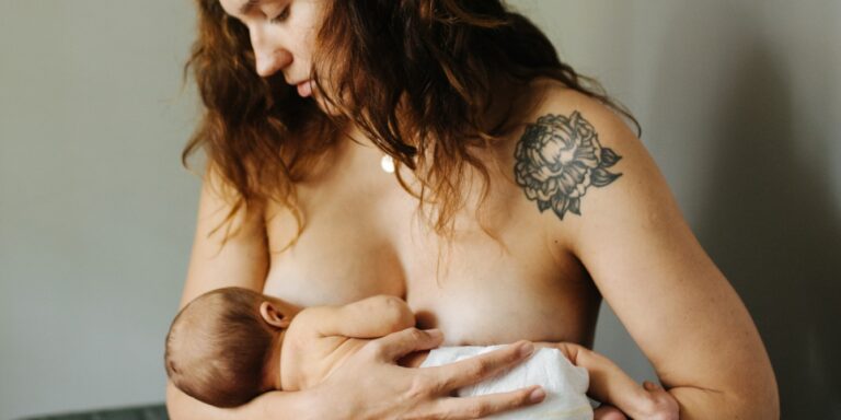 mother breastfeeding new baby
