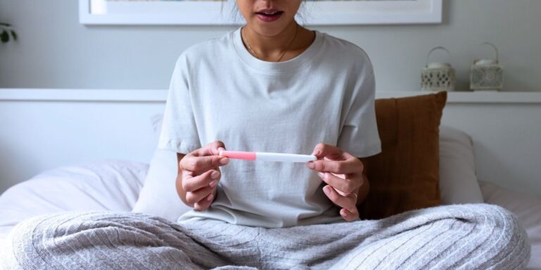 woman holding pregnancy test